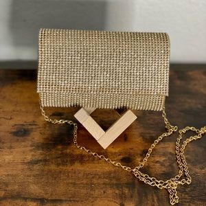 Cross body long gold chain with rhinestone clutch.